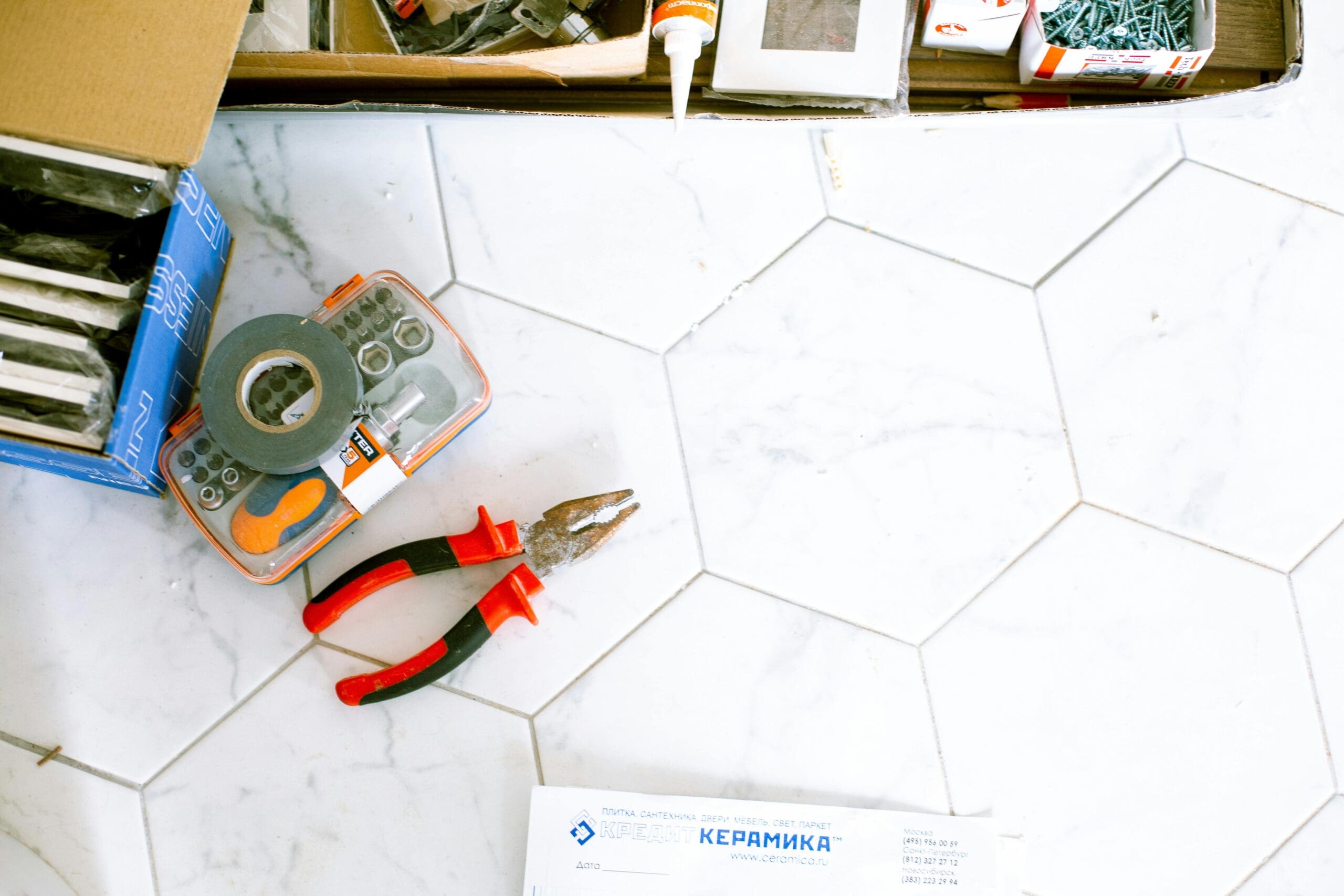 floor tile with pliers to show home renovations in knoxville